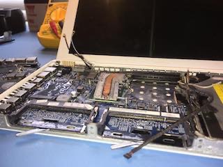 Photo of a MacBook main login board repair.